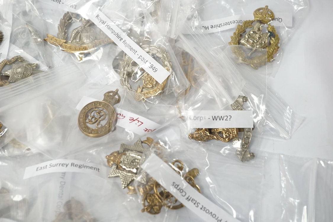 Forty military cap badges including; the Cambridgeshire regiment, Intelligence Corps, King’s Rifle Corps, Army Catering Corps, Small Arms School Corps, Duke of Wellington’s West Riding regiment, Royal Military College, R